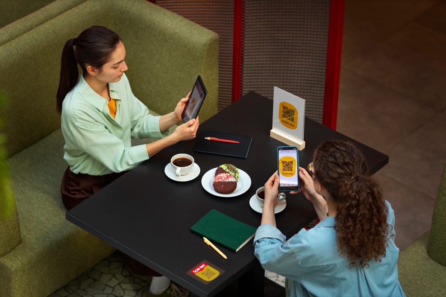 A customer scanning a QR code with their phone to order and pay